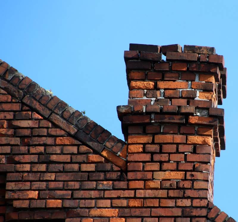 Signs Your Hurst Home Needs a Chimney Inspection Damaged chimney on an Hurst home showing cracks and missing mortar